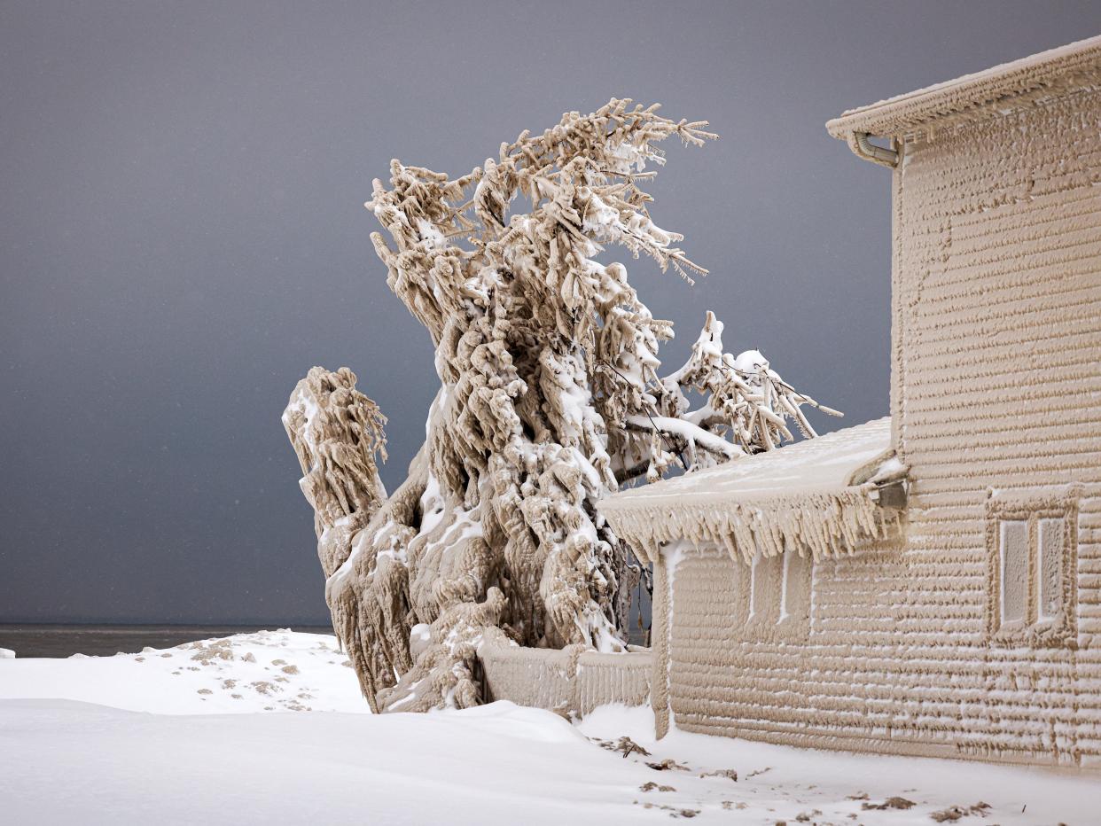 Ice formed by the spray of Lake Erie waves covers a house during a winter storm in Hamburg, New York, U.S., December 26, 2022.