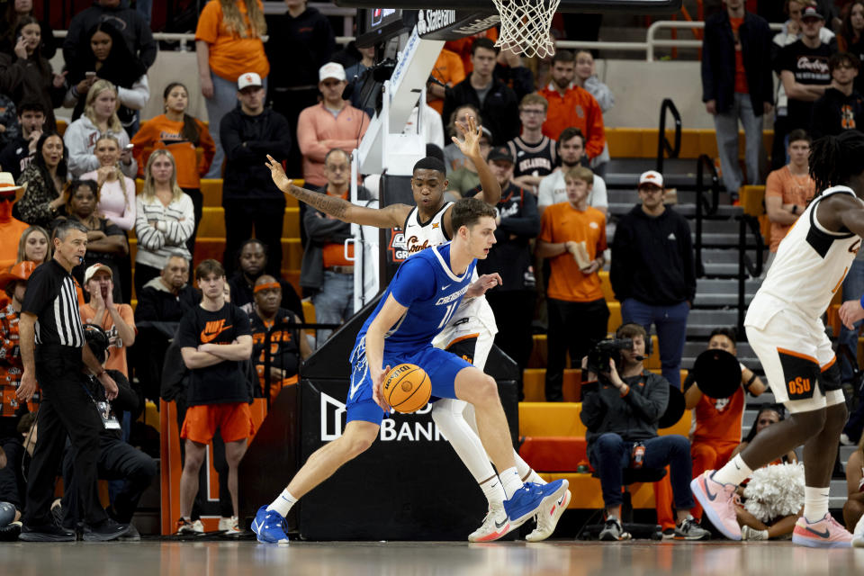 Creighton center Ryan Kalkbrenner drives past Oklahoma State center Brandon Garrison (23) in the second half of an NCAA college basketball game, Thursday, Nov. 30, 2023, in Stillwater, Okla. (AP Photo/Mitch Alcala)