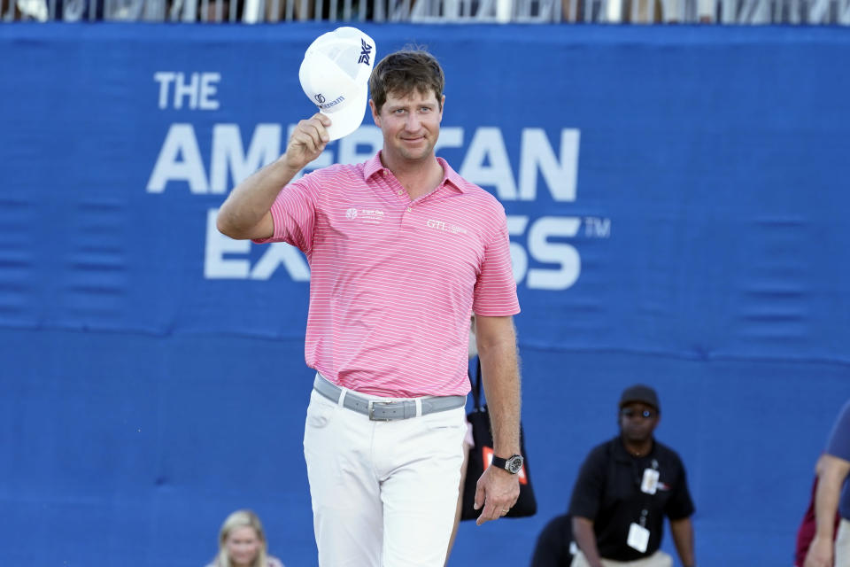Hudson Swafford tips his cap to the gallery after winning the American Express golf tournament on the Pete Dye Stadium Course at PGA West, Sunday, Jan. 23, 2022, in La Quinta, Calif. (AP Photo/Marcio Jose Sanchez)