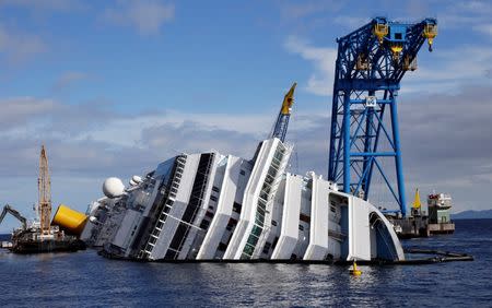 A general view of the capsized cruise liner Costa Concordia surrounded by cranes, near the harbour of Giglio Porto, October 12, 2012. REUTERS/Max Rossi