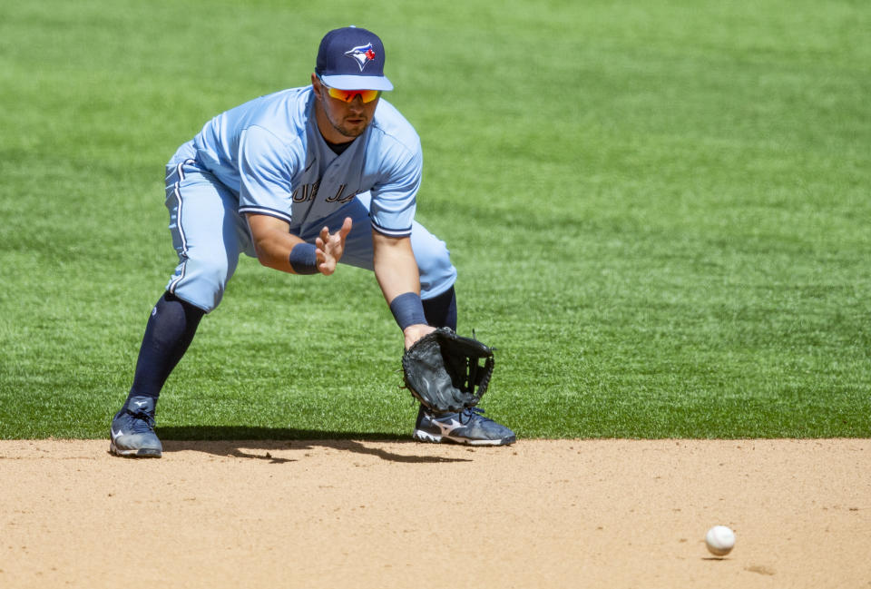 Toronto Blue Jays second baseman Joe Panik (2) fields a hit by Texas Rangers' Nick Solak (15) during the sixth inning of a baseball game, Wednesday, April 7, 2021, in Arlington, Texas. Texas won 2-1. (AP Photo/Brandon Wade)