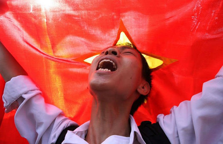 A protester shouts anti-China slogans in front of the Chinese embassy in Hanoi during a protest against the alleged invasion of Vietnamese territory by Chinese ships in disputed waters. Vietnam is set to hold live-fire naval drills on Monday in the South China Sea, as tensions with Beijing reach their highest levels in years over an escalating maritime dispute