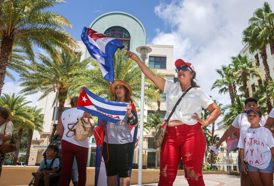 People take part in a rally at West Palm Beach city hall to support anti-government protesters in Cuba, Sunday, July 18, 2021.