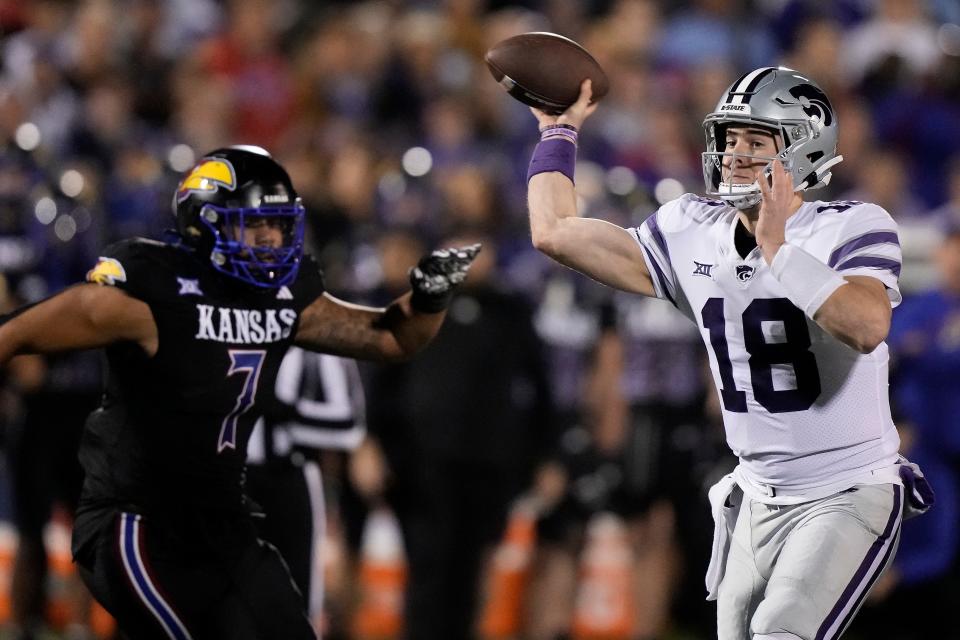 Kansas State quarterback Will Howard (18) passes during the first half of an NCAA college football game against Kansas Saturday, Nov. 18, 2023, in Lawrence, Kan. (AP Photo/Charlie Riedel)