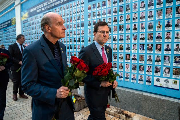 Reps. Bill Keating (D-Mass.), left, and Tom Kean Jr. (R-N.J.) place flowers at a memorial wall for Ukrainian soldiers at St. Michael Cathedral in Kyiv, Ukraine, on Monday. A bipartisan delegation of Congress members met President Volodymyr Zelenskyy in Kyiv on Monday and praised the historic House vote to approve military aid for the country.