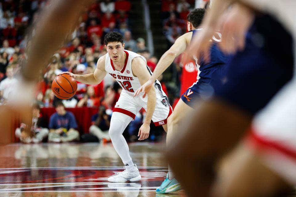 Jan 6, 2024; Raleigh, North Carolina, USA; North Carolina State Wolfpack guard Michael O'Connell (12) looks on with the ball during the first half against Virginia Cavaliers at PNC Arena. Mandatory Credit: Jaylynn Nash-USA TODAY Sports