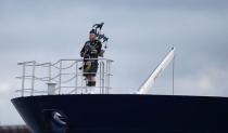 A piper plays as the tanker carrying the first shipment of U.S. shale gas passes under the Forth Bridge as it travels to dock at Grangemouth in Scotland, Britain September 27, 2016. REUTERS/Russell Cheyne