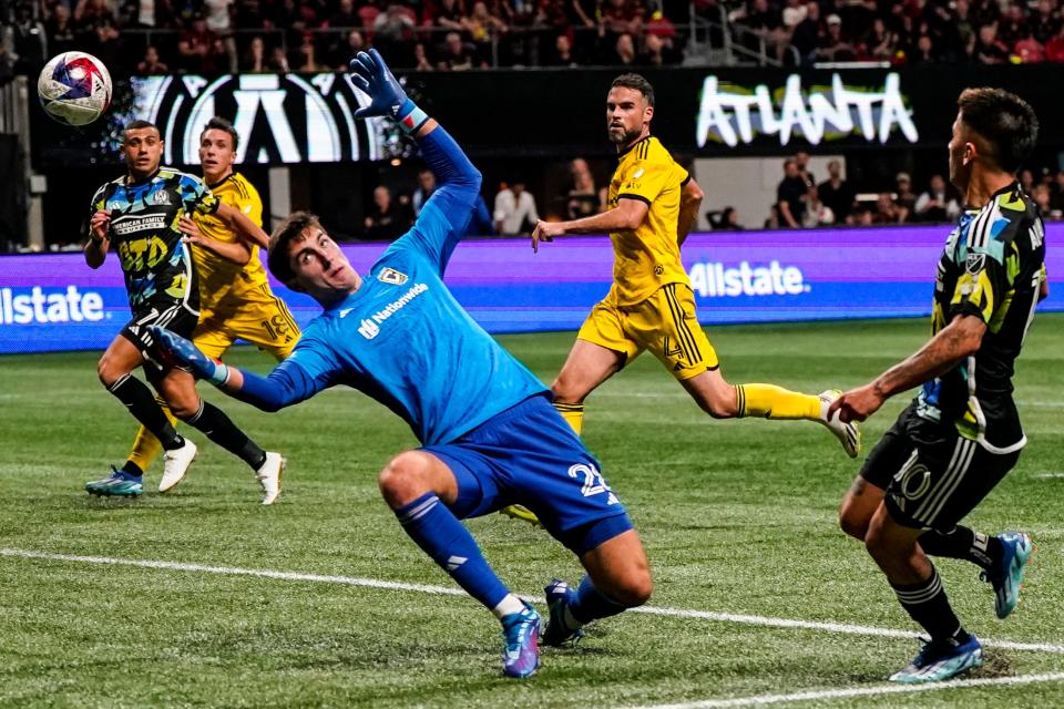Columbus Crew goalkeeper Patrick Schulte (28) misses the ball as Atlanta United's Thiago Almada (10) scores a goal during the second half of an MLS playoff soccer match, Tuesday, Nov. 7, 2023, in Atlanta. (AP Photo/Mike Stewart)