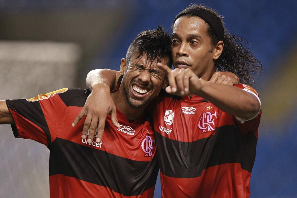 RIO DE JANEIRO, BRAZIL - APRIL 07: Ronaldinho (R) and Leo Moura of Flamengo celebrate a scored goal aganist  Vasco during a match between Flamengo and Vasco as part of Rio State Championship 2012 at Engenhao stadium on April 07, 2012 in Rio de Janeiro, Brazil. (Photo by Buda Mendes/LatinContent/Getty Images)