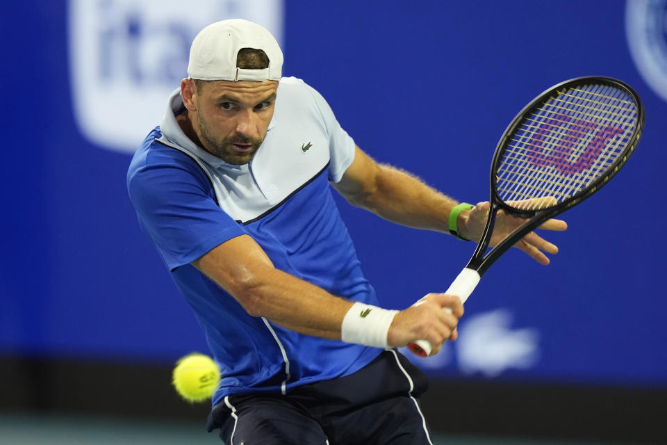 Grigor Dimitrov of Bulgaria returns the ball to Carlos Alcaraz of Spain during the Miami Open tennis tournament, Thursday, March 28, 2024, in Miami Gardens, Fla. (AP Photo/Marta Lavandier)