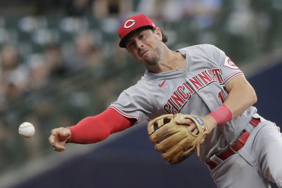 Cincinnati Reds' Kyle Farmer throws out Milwaukee Brewers' Avisail Garcia at first base during the third inning of a baseball game Monday, June 14, 2021, in Milwaukee. (AP Photo/Aaron Gash)