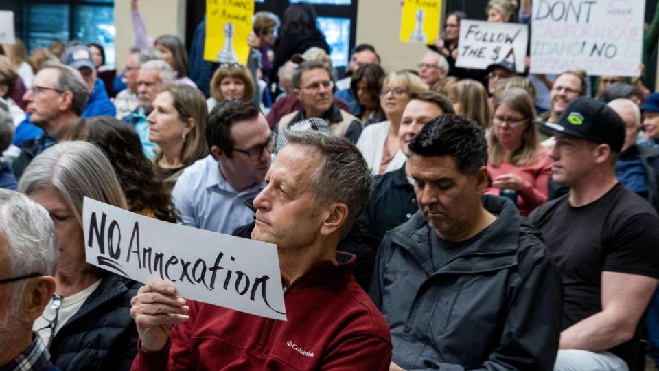 Signs, including this one held by Eagle resident David Spritzer in March 2023 during debate over the annexation ov Avimor, will be prohibited during public hearings going forward.