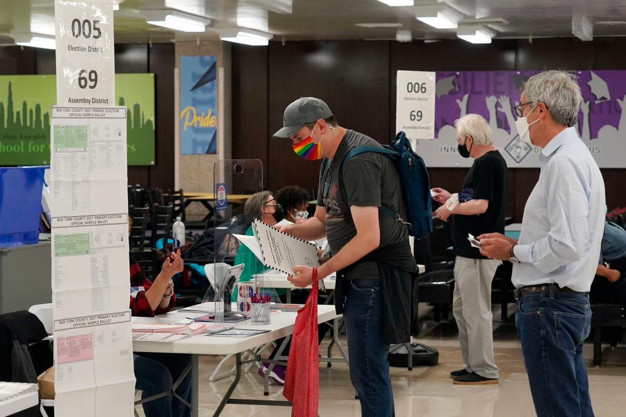 Voters receive their ballots at Frank McCourt High School, in New York on Tuesday, June 22, 2021.