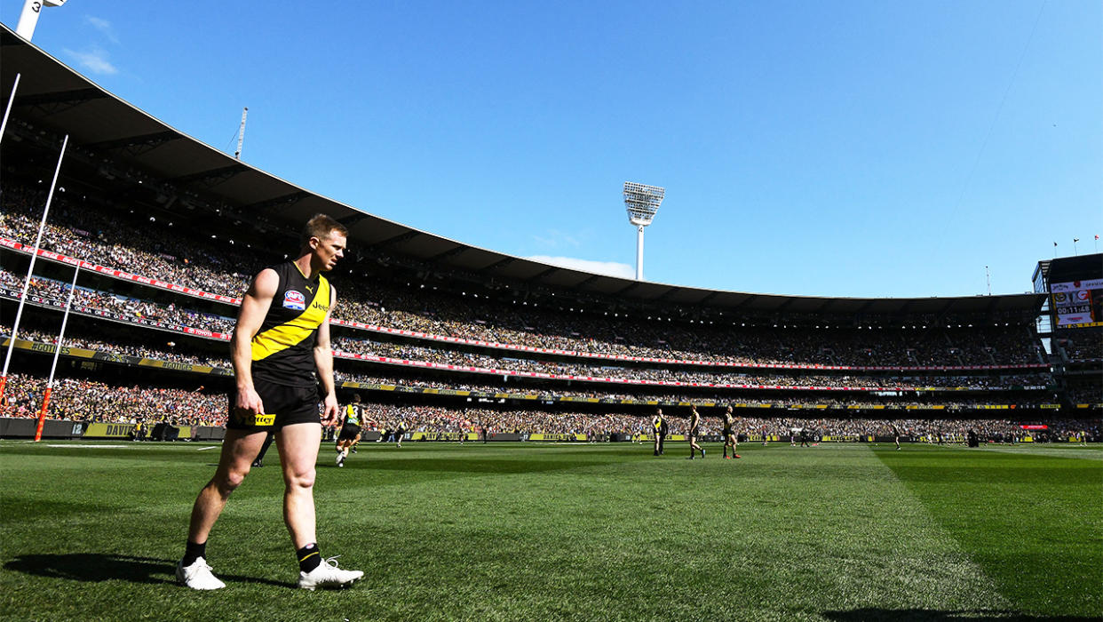 Richmond player walks on the MCG turf during the AFL Grand Final.