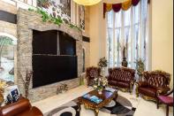 <p>There’s plenty of space to relax at the eight-bedroom pad — kick back in this ornate living room. (Airbnb) </p>