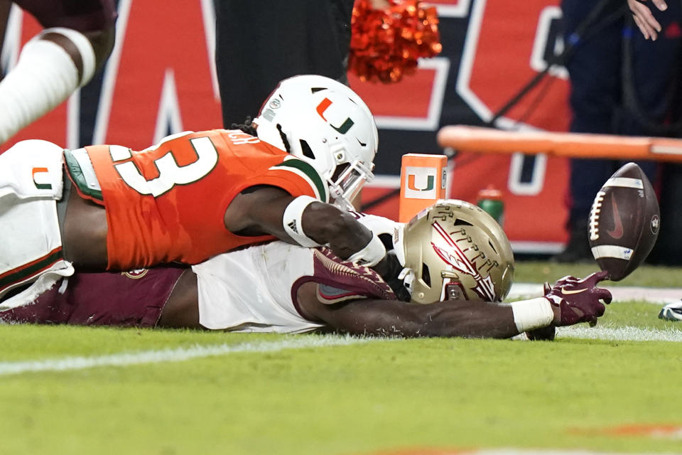 Florida State running back Trey Benson (3), right, scores a touchdown as Miami cornerback Te'Cory Couch (23) defends during the first half of an NCAA college football game, Saturday, Nov. 5, 2022, in Miami Gardens, Fla. (AP Photo/Lynne Sladky)