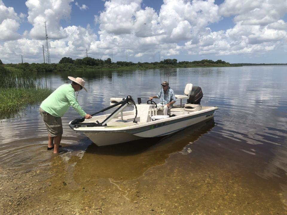 Gary Sharpe launches his boat from the shore at the Lake Manatee Fish Camp on Thursday.