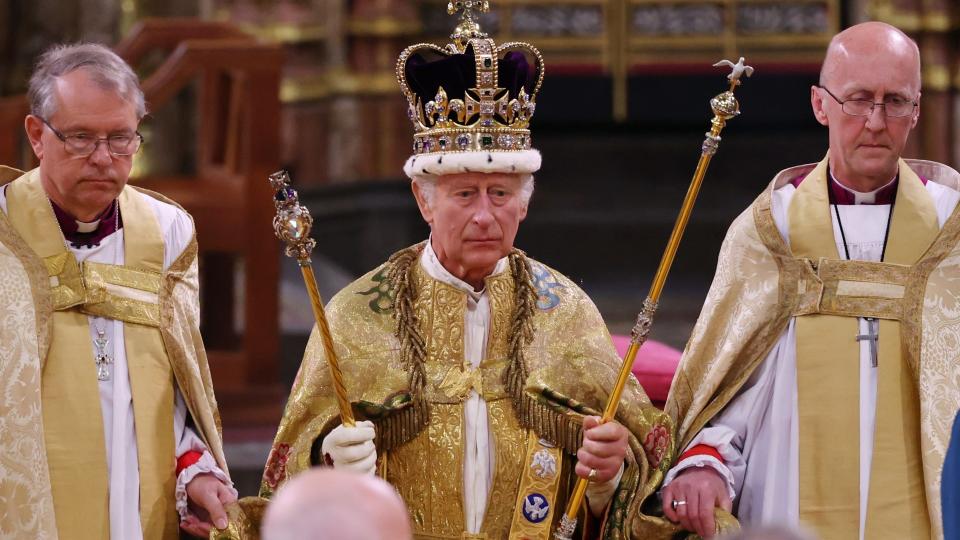 King Charles III stands after being crowned during his coronation