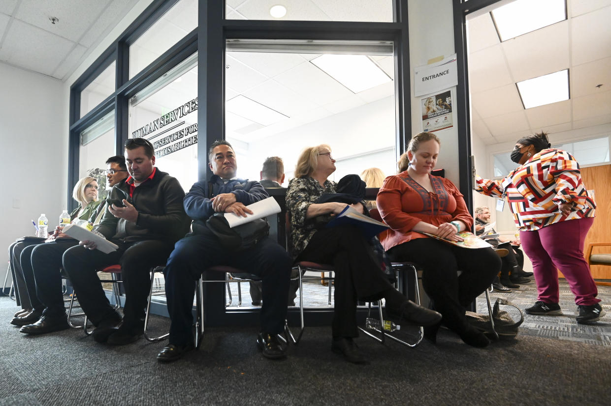 Job seekers wait at an Internal Revenue Service job fair in Clearfield, Utah. (Credit: Alex Goodlett for The Washington Post via Getty Images)