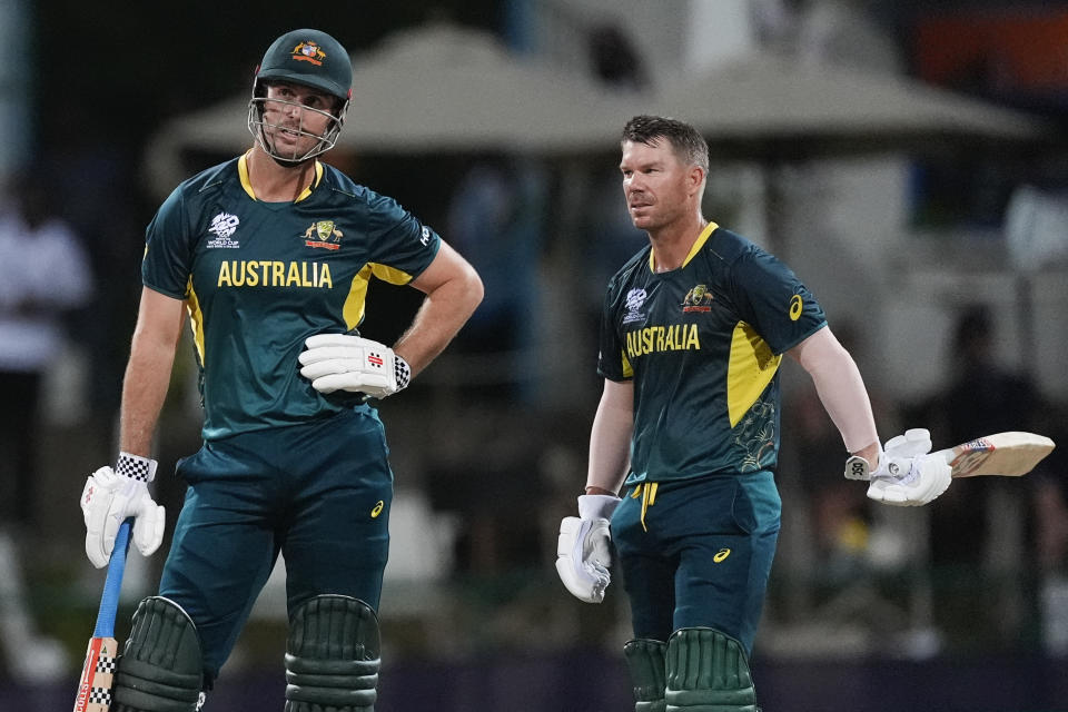 Australia's captain Mitchell Marsh, left, waits for a video review after been given out LBW as teammate David Warner watches during the ICC Men's T20 World Cup cricket match between Australia and Bangladesh in North Sound, Antigua and Barbuda, Thursday, June 20, 2024. (AP Photo/Lynne Sladky)