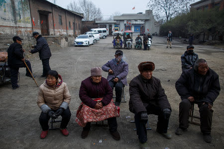 Locals wait for the start of a Chinese opera performance that Xinyuan Steel put on for locals and employees to mark the end of Chinese New Year festivities in Anyang, Henan province, China, February 19, 2019. REUTERS/Thomas Peter
