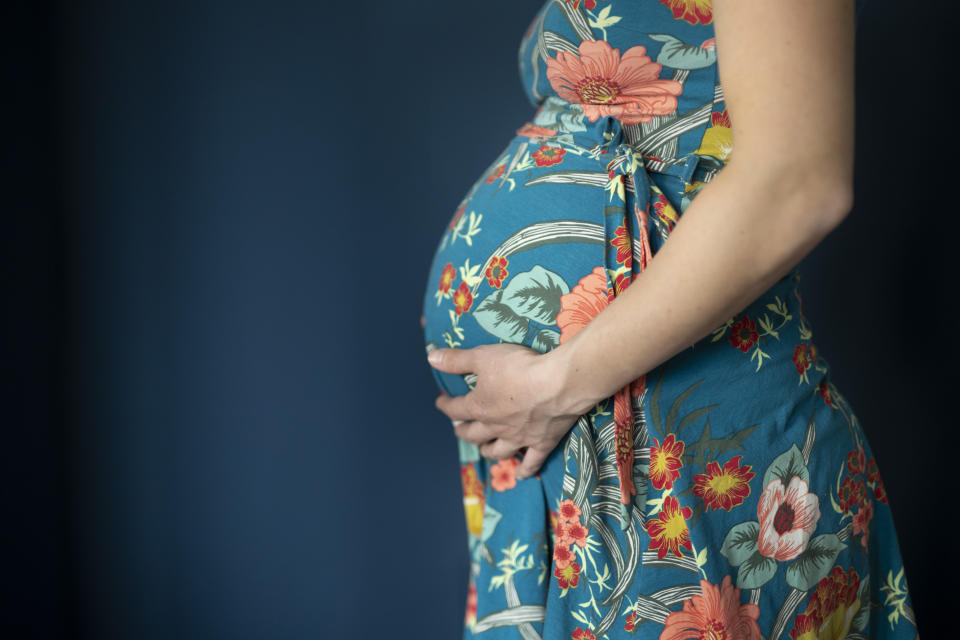 Bonn, Germany - February 26:  In this photo illustration a young pregnant woman is holding her baby bump on February 26, 2021 in Bonn, Germany. (Photo by Ute Grabowsky/Photothek via Getty Images)