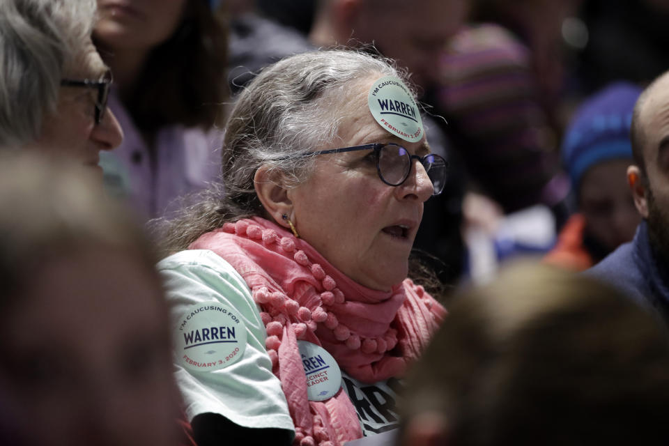 In this Feb. 3, 2020, photo, a woman caucusing for Democratic presidential candidate Sen. Elizabeth Warren, D-Mass., sits in the Warren section at the Precinct 68 caucus at the Knapp Center on the Drake University campus as the night of caucusing gets underway in Des Moines, Iowa. After female candidates helped power the Democratic party to retake the House in 2018 the party's women seem only moderately enthusiastic about voting for a woman for president. AP VoteCast found women in Iowa were only slightly more likely to back a woman than a man. (AP Photo/Gene J. Puskar)