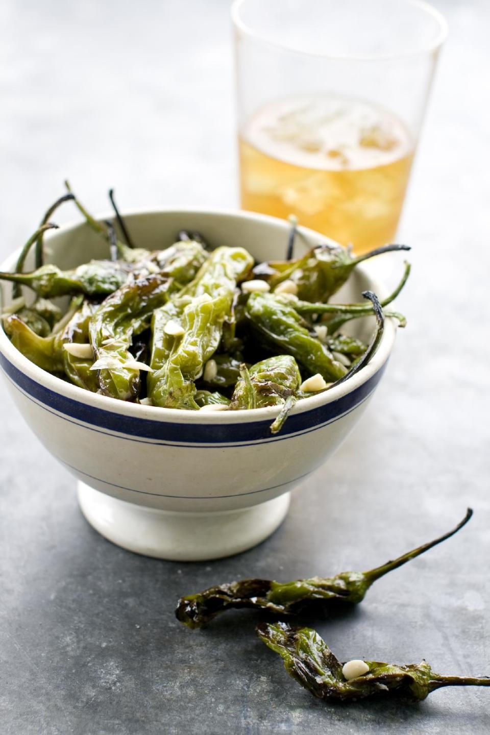 This June 10, 2013 photo taken in Concord, N.H. shows a recipe for grilled shishito peppers. (AP Photo/Matthew Mead)