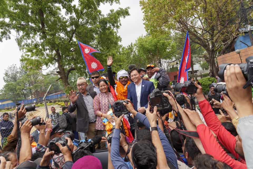 Hari Budha Magar, former Gurkha veteran and double amputee climber who scaled Mount Everest, is welcomed upon arrival at the airport in Kathmandu, Nepal, Tuesday, May 23, 2023. The former Gurkha veteran had lost both his legs in Afghanistan when he accidentally stepped on an improvised explosive device in 2010. Magar, who was a soldier in the Gurkha regiment, was born in a remote mountain village in Nepal and later was recruited by the British army. He now lives with his family in Canterbury, England. (AP Photo/Niranjan Shrestha)