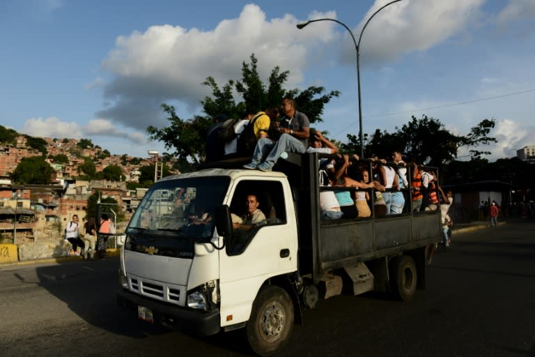People ride on a truck turned bus in a Caracas slum -- one way to deal with a transport mess that is part of Venezuela's economic crisis