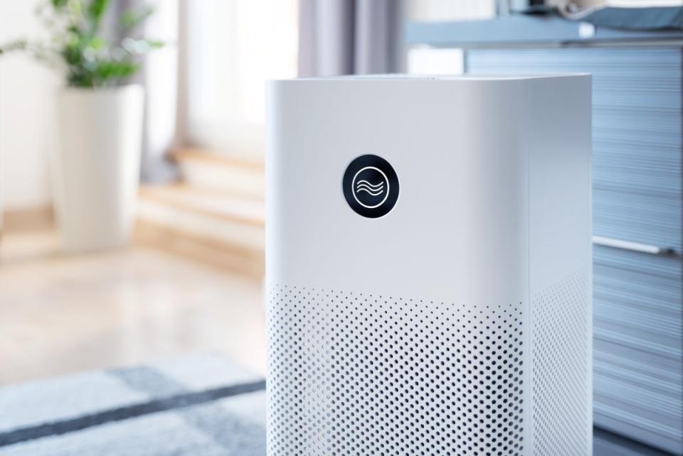 A white air purifier in a modern-looking living space