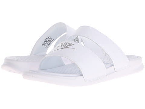 <strong>Sizes</strong>: 5 - 12<br /><a href="https://www.zappos.com/p/nike-benassi-duo-ultra-slide-white-metallic-silver/product/8619510/color/2446" target="_blank" rel="noopener noreferrer">Shop them here.</a>
