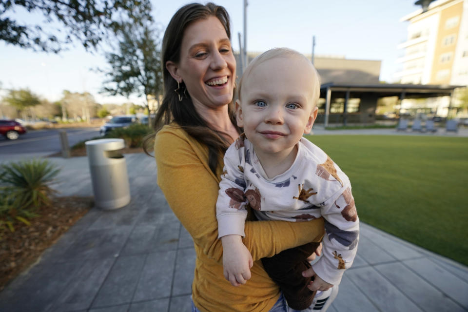 Kelly Crim, playing with her 15-month old son Liam in northeast Jackson, Miss., on Feb. 13, 2023, said she supports expanding the territory for Capitol Police into the part of Mississippi's capital city where she and her family live, but was unaware of a proposal to create a new court with appointed rather than elected judges. (AP Photo/Rogelio V. Solis)