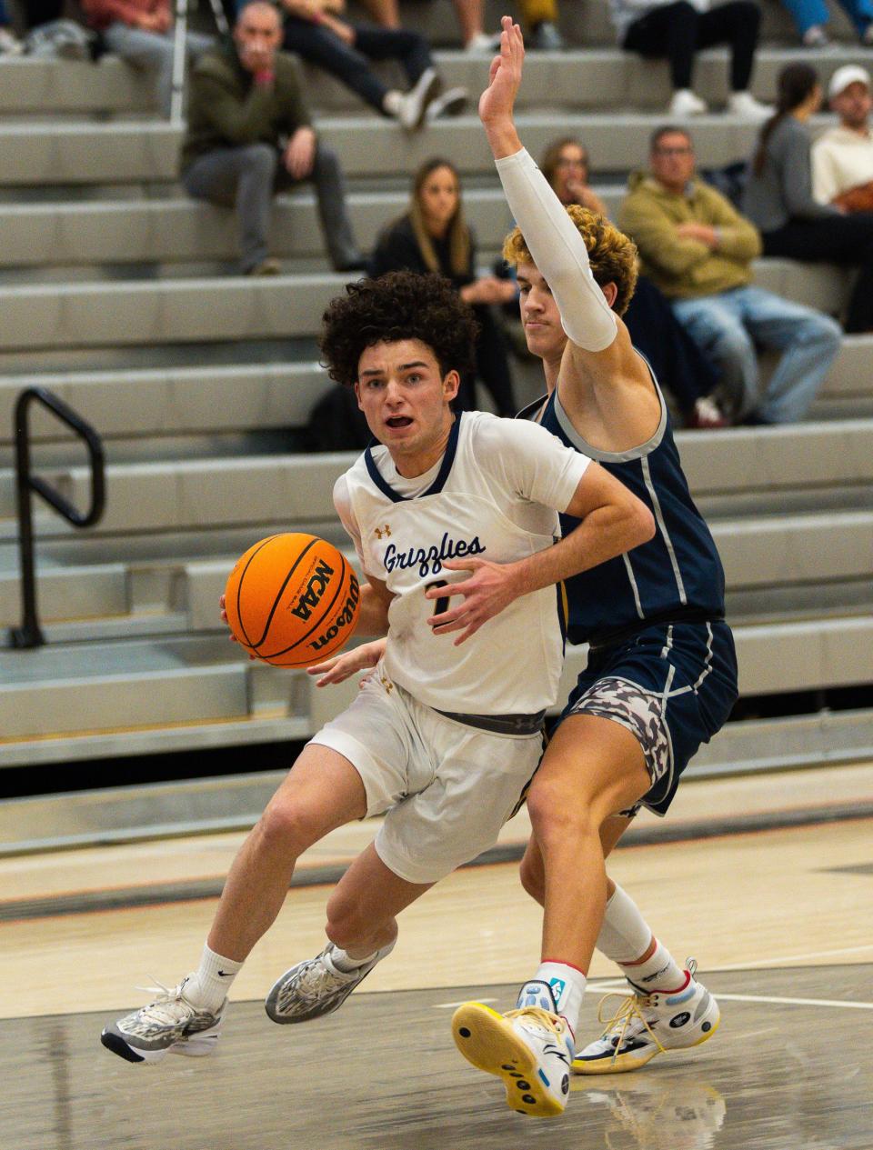 Copper Hills High School’s Isaiah Reiser drives the ball with Crimson Cliffs High School’s Luke Johnson on defense during a boys basketball semifinal game of the Allstate Falcon Classic at Skyridge High School in Lehi on Friday, Dec. 8, 2023. | Megan Nielsen, Deseret News