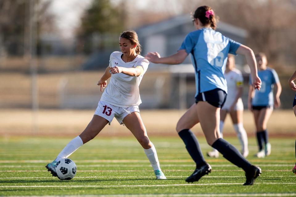 Rocky Mountain's Jace Holley controls the ball during a game against Poudre High School in Fort Collins on March 19.