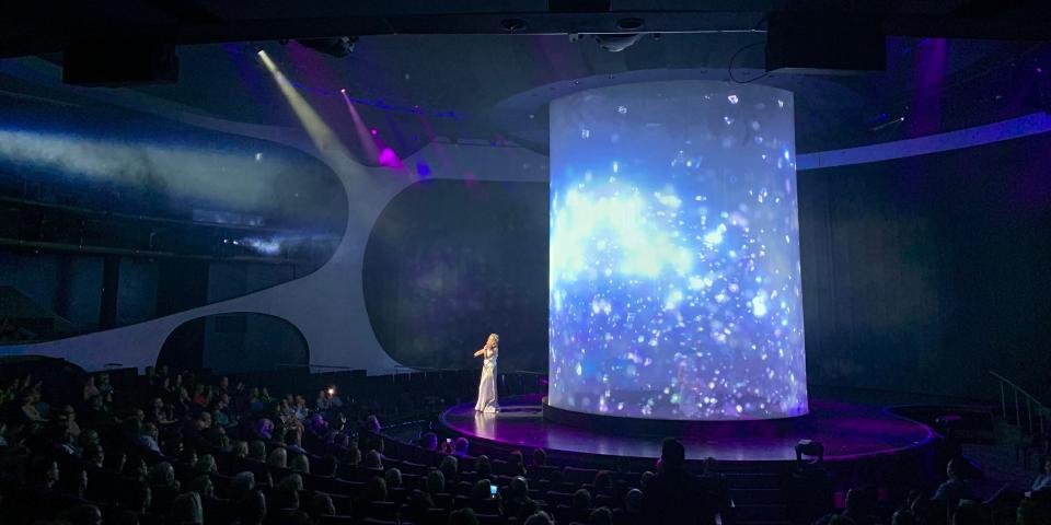 a woman playing violin during a live show