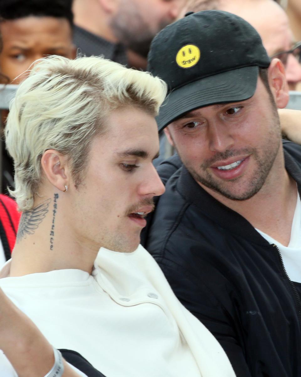 Justin Bieber (L) and Scooter Braun attend Sir Lucian Grainge honored with a Star on the Hollywood Walk of Fame on January 23, 2020 in Hollywood, California.