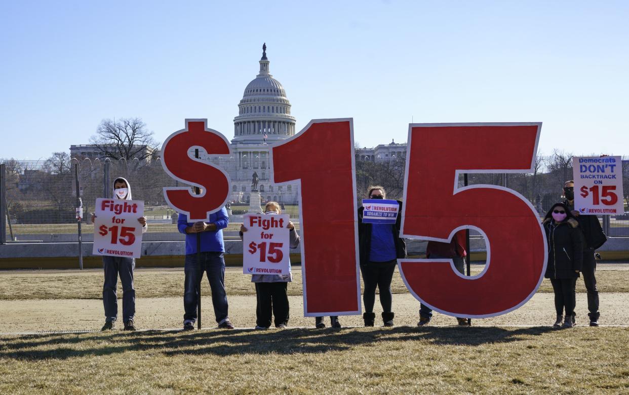 Activists appeal for a $15 minimum wage near the Capitol in Washington, Thursday, Feb. 25, 2021. The $1.9 trillion COVID-19 relief bill being prepped in Congress includes a provision that over five years would hike the federal minimum wage to $15 an hour. 