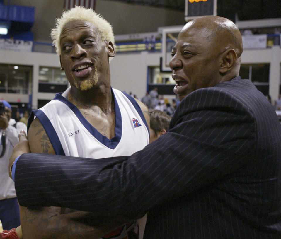 FILE - Long Beach Jam's Dennis Rodman gets a hug from coach Earl Cureton after their victory over the Kansas City Knights in the American Basketball Association Championship at the Pyramid in Long Beach Calif., Tuesday, March 9, 2004. Cureton, who won two NBA championships in 12 seasons in the league, died Sunday, Feb. 4, 2024. He was 66. (AP Photo/Chris Carlson, File)