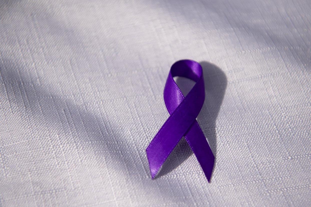 A purple ribbon of support sits on a table during the Rally Against Domestic Violence at the Ohio Statehouse in Columbus in October 2021.