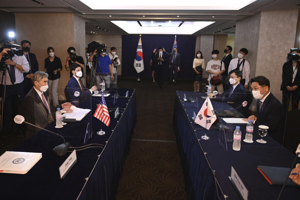U.S. special representative for North Korea Sung Kim, left, talks with South Korea's Special Representative for Korean Peninsula Peace and Security Affairs Noh Kyu-duk, right, during their bilateral meeting at a hotel in Seoul Monday, June 21, 2021. (Jung Yeon-je/Pool Photo via AP)
