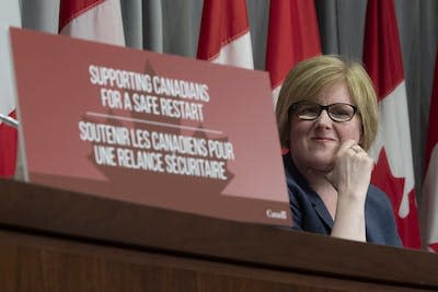Employment Minister Carla Qualtrough listens to a question during a news conference in Ottawa in August 2020. THE CANADIAN PRESS/Adrian Wyld