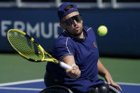 Dylan Alcott, of Australia, returns to Bryan Barten, of the United States, during a men's wheelchair quad quarterfinals match at the U.S. Open tennis tournament in New York, Friday, Sept. 10, 2021, in New York. (AP Photo/John Minchillo)