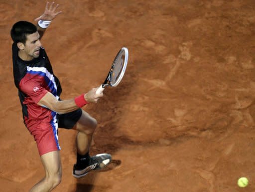 Serbia's Novak Djokovic returns a ball to Swiss Roger Federer during their semi-finals match of the ATP Rome tournament. Djokovic ended Federer's brilliant run of recent clay form, defeating the world number two, and last week's Madrid champion, 6-2, 7-6 (7/4)