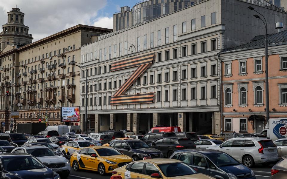 Cars stuck in traffic in front of a theatre building decorated with the letter Z in Moscow, Russia, 30 March 2022.  - Photo by YURI KOCHETKOV/EPA-EFE/Shutterstock