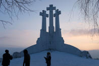 <p>Visitors stand on the Hill of Three Crosses, one of the city’s major landmarks, the day before the 100th anniversary of the restoration of Lithuanian statehood on February 15, 2018 in Vilnius, Lithuania. Celebrations will take place throughout tomorrow to mark the day on February 16, 1918 when, as World War I was grinding towards its end, signatories launched the Act of Reinstating the Independence of Lithuania. (Photo by Sean Gallup/Getty Images) </p>