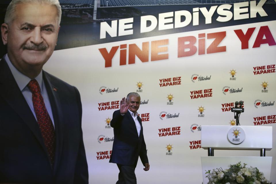 Binali Yildirim mayoral candidate for Istanbul waves to his supporters at Turkey's ruling Justice and Development Party, AKP, offices in Istanbul, Sunday, June 23, 2019. Turkish government's candidate for Istanbul mayor concedes defeat after first results from rerun election are reported. (AP Photo/Emrah Gurel)