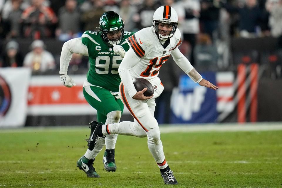 Cleveland Browns quarterback Joe Flacco runs past New York Jets defensive tackle Quinnen Williams on Dec. 28, 2023, in Cleveland.