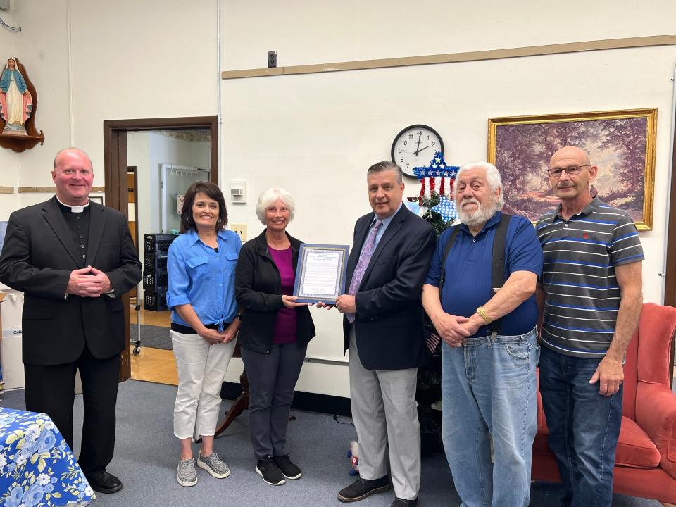 Ellwood City Mayor Anthony Court presents a proclamation June 14, 2023, to members of the Divine Grace Ministerium Social Services and Food Bank.