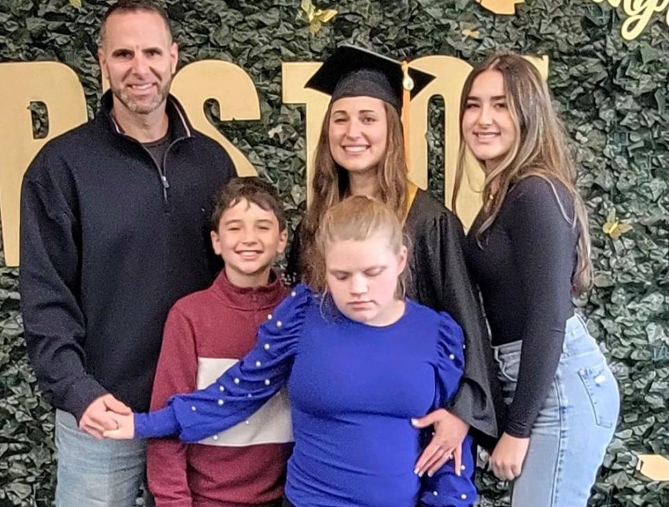 Aimee Rodrigues (center) with her immediate family: husband, Mark (left); son Jack; daughter, Ava (right); and daughter Leanna (center). Photo was taken at Bristol Community College Commencement on May 18, 2024.